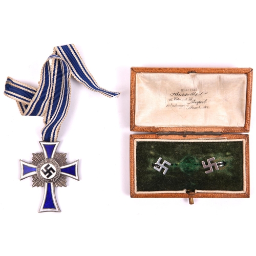 108 - Third Reich Mother's Cross in silver, with ribbon; and a pair of modern swastika ear studs in non-or... 