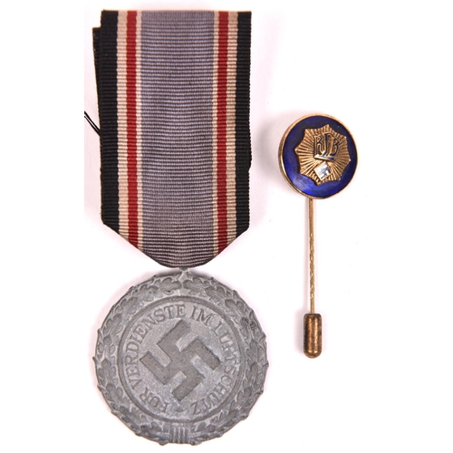 113 - Third Reich grey metal Luftschutz Service medal, with ribbon; and RLB enamelled stick pin. GC