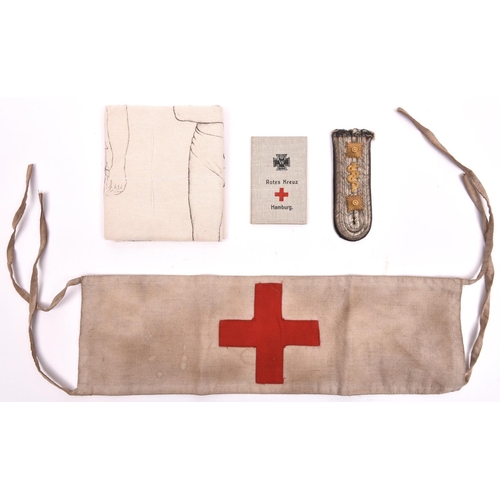 126 - A WW1 German tie-on linen Red Cross armband, with indistinct official rubber stamps; a linen arm sli... 