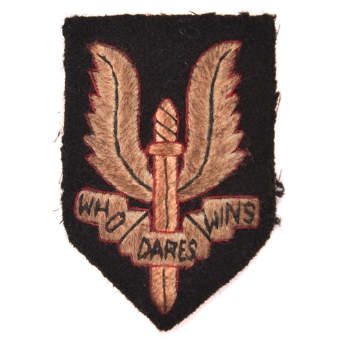 240 - An embroidered Special Air Service large size beret badge, on black cloth shield backing,. GC (soile... 