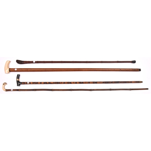 266 - 3 walking sticks slender bamboo, the polished dark green stone handle having a gold – coloured band;... 