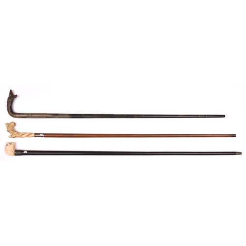 271 - 2 walking sticks pale wood with ivory handle carved with roses entwined around a twisted stump; and ... 