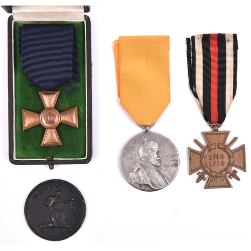 82 - A 1916 “Iron for Gold” medallion; a Prussian 15 year Long Service medal, in a case; 1914-18 Honour C... 