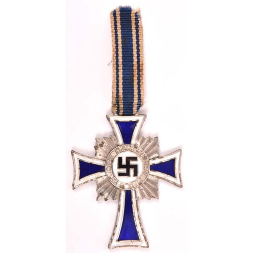 89 - A Third Reich Mother's Cross in silver, with short length of ribbon. GC (a few small black spots on ... 