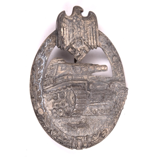 90 - A Third Reich Panzer Assault badge,  of die-stamped grey metal with traces of silver finish, and wit... 