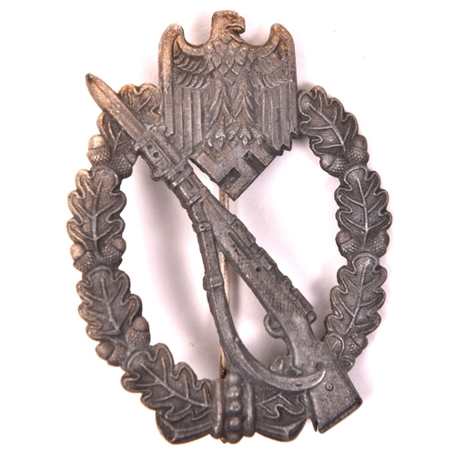 91 - A Third Reich Infantry Assault badge, of grey metal with feint traces of silver finish, round wire p... 