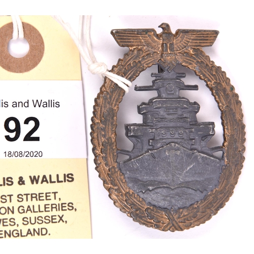 92 - A Third Reich High Seas Fleet badge, gilt washed wreath with grey centre, and distinctive recessed b... 