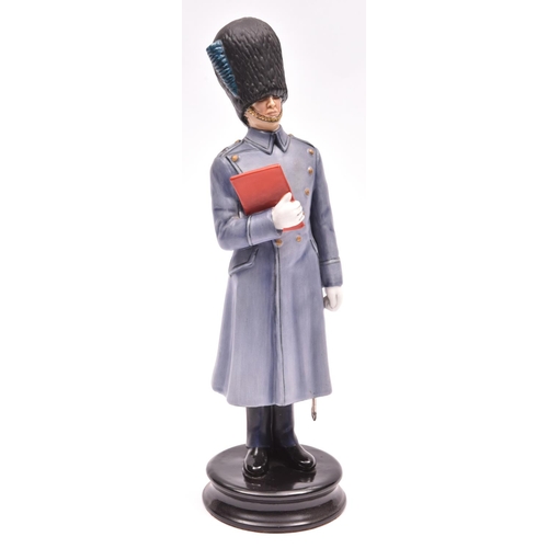 22 - A fine Michael Sutty painted porcelain figure of an officer of the Irish Guards, in great coat and h... 