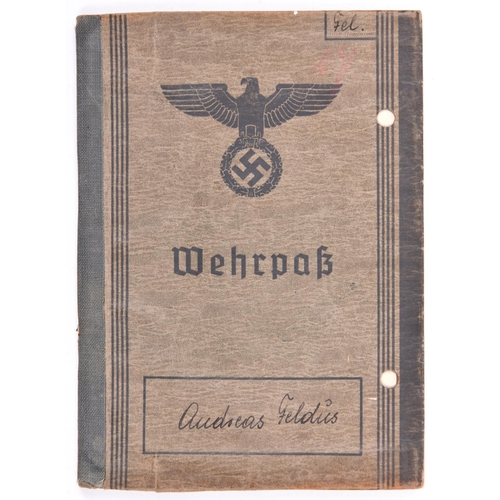 44 - A Third Reich Wehrpass, to Andreas Geldus, who joined the Waffen SS in 1942, being promoted to Rotte... 