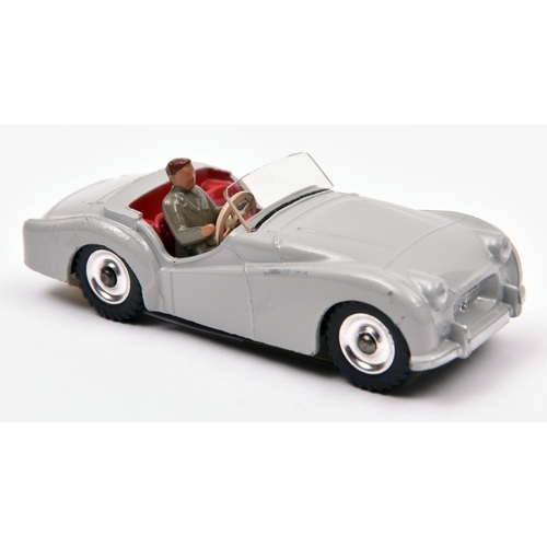 379 - Dinky Toys Triumph TR2 Touring finish (105). In light grey with red interior, with driver and spun w... 