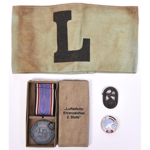 185 - A Third Reich Luftschutz medal, with ribbon, in case of issue; 2 other Luftschutz badges, and a gree... 