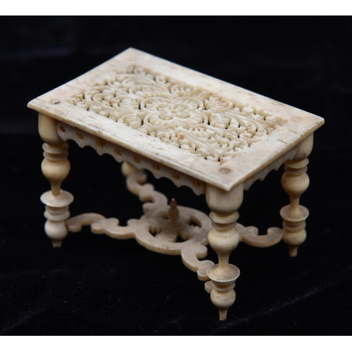 12 - A very finely worked mid 19th Century oriental ivory/bone doll's house model table with 17th Century... 