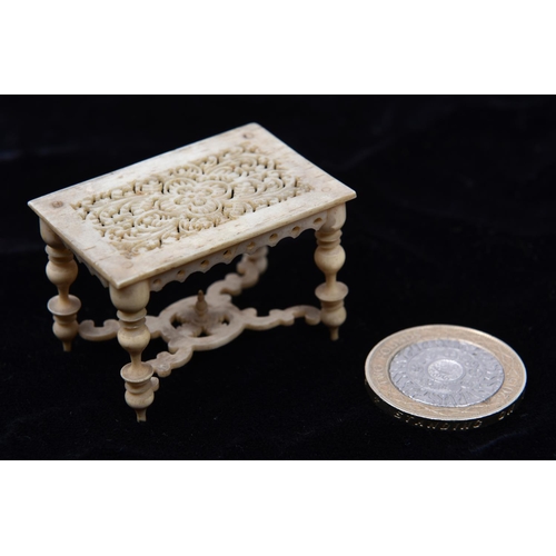 12 - A very finely worked mid 19th Century oriental ivory/bone doll's house model table with 17th Century... 