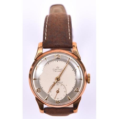 206 - A Smiths De Luxe watch with manual winding mechanism. With metallic silvered face and gold arabic nu... 