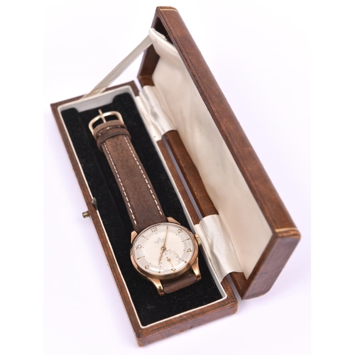 206 - A Smiths De Luxe watch with manual winding mechanism. With metallic silvered face and gold arabic nu... 