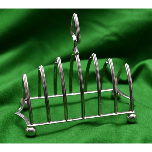 36 - A 7-bar silver toast rack with simple gothic arches. Hallmarked Sheffield, 'J.H.P'. VGC. 207g. £50-7... 