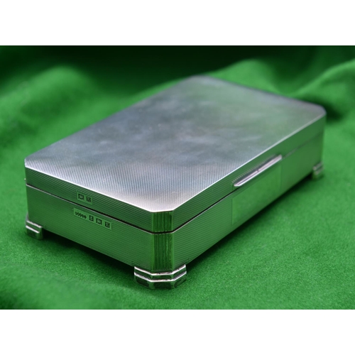 49 - A silver cigarette box with engine turned decoration to lid and sides, cedar lined interior and rais... 