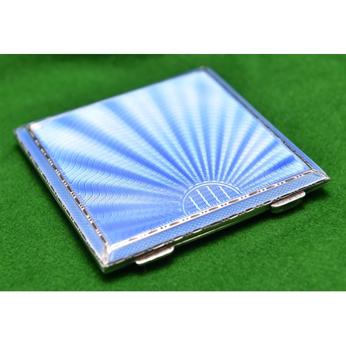 54 - A silver powder compact with engine turned case, blue guilloché enamel lid and fitted mirror inside.... 