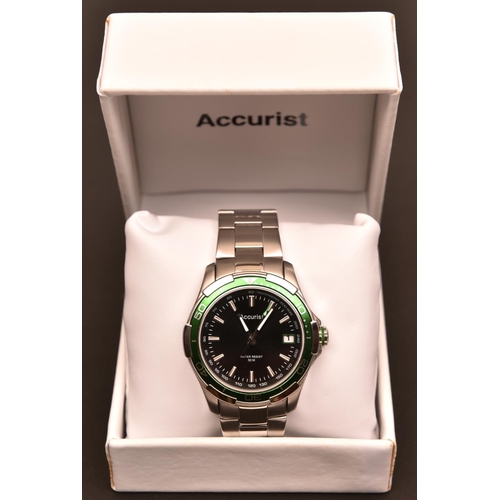 82 - An Accurist MB907GB watch with quartz movement. Black and metallic green face with date display. Wit... 