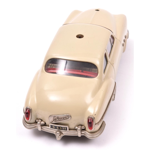 117 - Schuco - Patient-Ingenico 5311 Tinplate 2 Door Saloon. A 1950's American style car in beige with a l... 