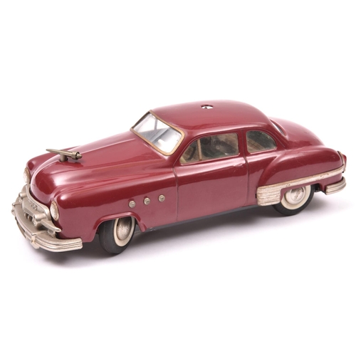 120 - Schuco - Patient-Ingenico 5311 Tinplate 2 Door Saloon. A 1950's American style car in maroon with a ... 