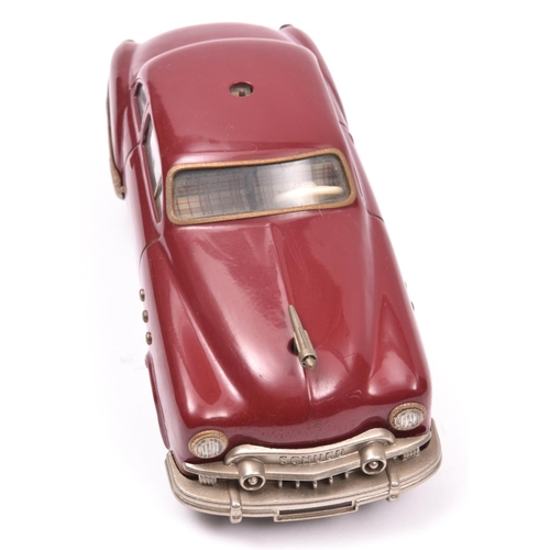 120 - Schuco - Patient-Ingenico 5311 Tinplate 2 Door Saloon. A 1950's American style car in maroon with a ... 