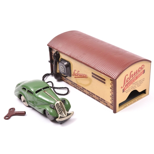 122 - Schuco 15/200P tinplate set. Comprising a two door saloon in dark green, fitted with a clockwork mot... 