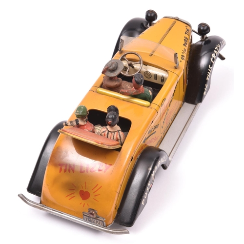 128 - A scarce Arnold Tinplate friction powered 'Tin Lizzy'. In deep yellow with black mudguards, graffiti... 