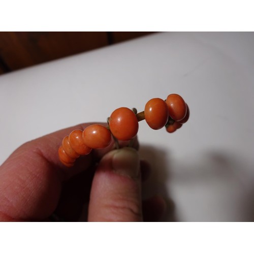 6 - A Victorian red coral hair clip made up of 11 coral beads on a metal frame. Together with a tie pin ... 