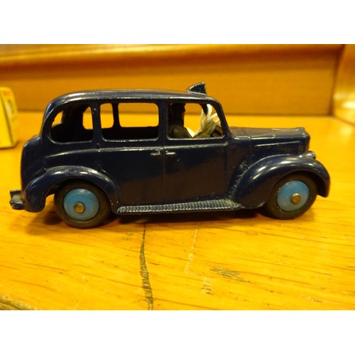 425 - Dinky Toys Austin Taxi (254). A scarce example in dark blue with mid blue wheels and black tyres. Bo... 