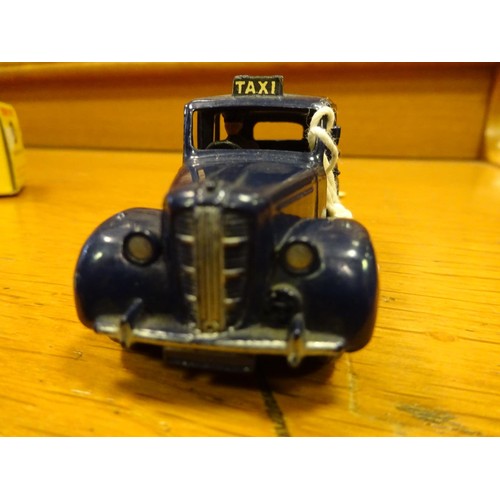 425 - Dinky Toys Austin Taxi (254). A scarce example in dark blue with mid blue wheels and black tyres. Bo... 