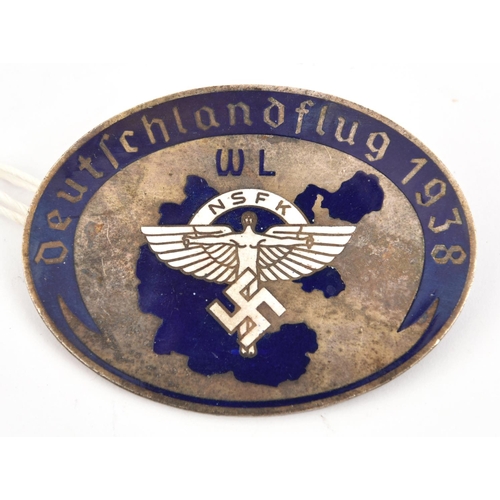 79 - A Third Reich oval pin back enamelled badge,   with white NSFK device in the centre with initials “W... 