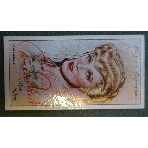 20 - A collection of 27 autographed cigarette cards of film and radio stars including Mae West (signed in... 