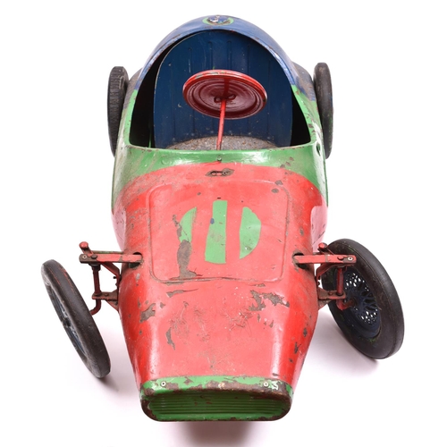 260 - A late 1950's early 1960's Tri-ang Childs Peddle Car. A heavy tinplate toy in the style of a Vanwall... 