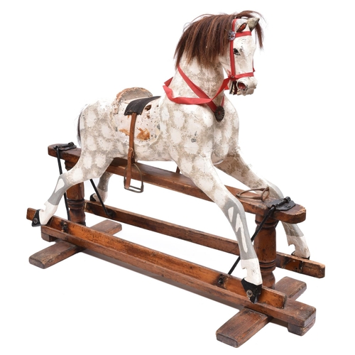 261 - A traditional English children's hand carved wooden rocking horse. This half size horse has been fin... 