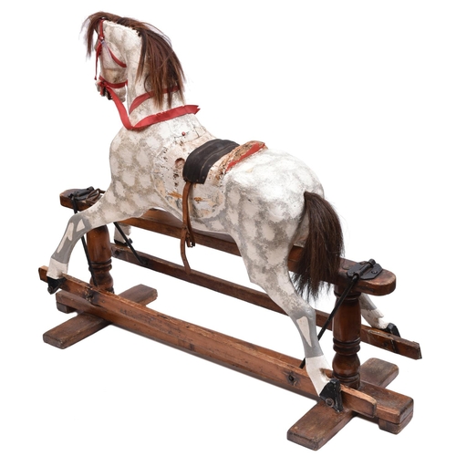 261 - A traditional English children's hand carved wooden rocking horse. This half size horse has been fin... 