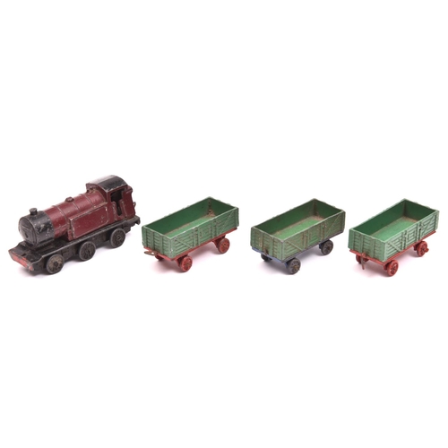 490 - Dinky Toys Tank Goods Train Set.  Maroon/black locomotive, two green/red open wagons, with a third o... 