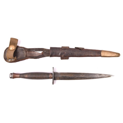 175 - A third pattern FS fighting knife,  with blued blade, the bronzed hilt stamped with small broad arro... 