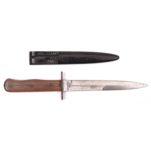 176 - A German WWII fighting knife, blade 6¾” bearing inspection mark on one side, the other side etched “... 