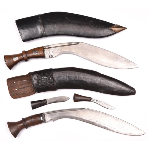 197 - A kukri,   with plain wood hilt, in its leather covered sheath with belt loop and 2 companion knives... 