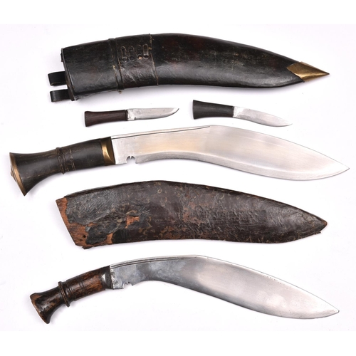 201 - A kukri,    with brass mounted horn hilt, in its leather covered sheath with belt loops and two comp... 