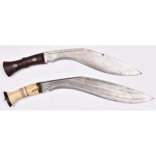 203 - A kukri, with riveted wood grips, the blade stamped “D.K.W”; and another kukri, with brass mounted b... 