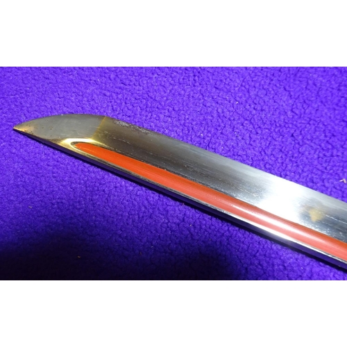 266 - A katana blade in shirasaya,  with full length grooves, red lacquered running down into the O-suriag... 