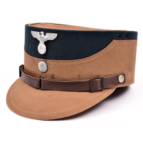 76 - A Third Reich SA man's brown kepi, green cloth crown with alloy eagle and buttons, brown leather lin... 