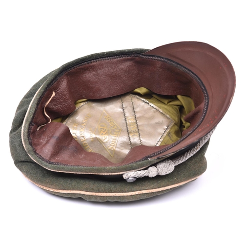 108 - A copy of a Third Reich SS officer's cap, with metal skull and eagle, silver bullion cords and fibre... 