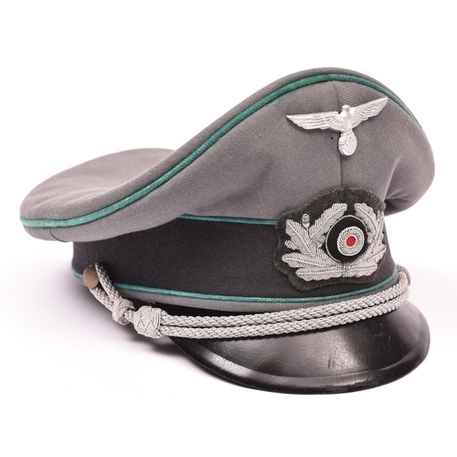 109 - A Third Reich type army officers peaked cap, alloy wire badge and chin cords, alloy eagle badge, lig... 