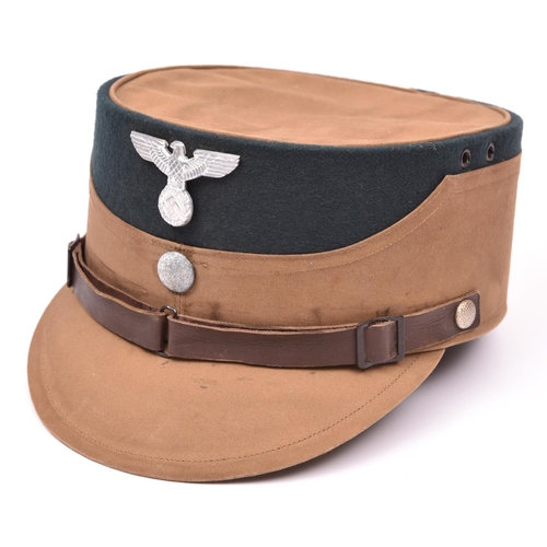 76 - A Third Reich SA man's brown kepi, green cloth crown with alloy eagle and buttons, brown leather lin... 