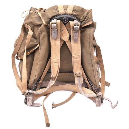 115 - A WWII British Army Bergen rucksack, green canvas with brass and leather fittings, dated 1945, GC £3... 