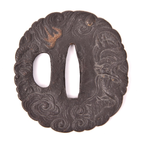 284 - An iron tsuba depicting a dragon in clouds, gold detail, GC £100-150