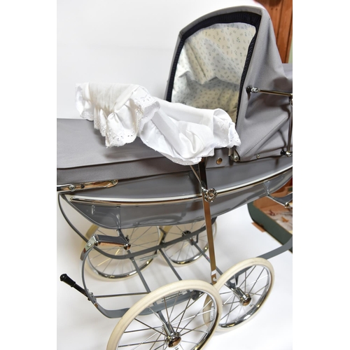 223 - A Silver Cross Doll's Pram. A very substantially built modern issue of this classic pram with gloss ... 